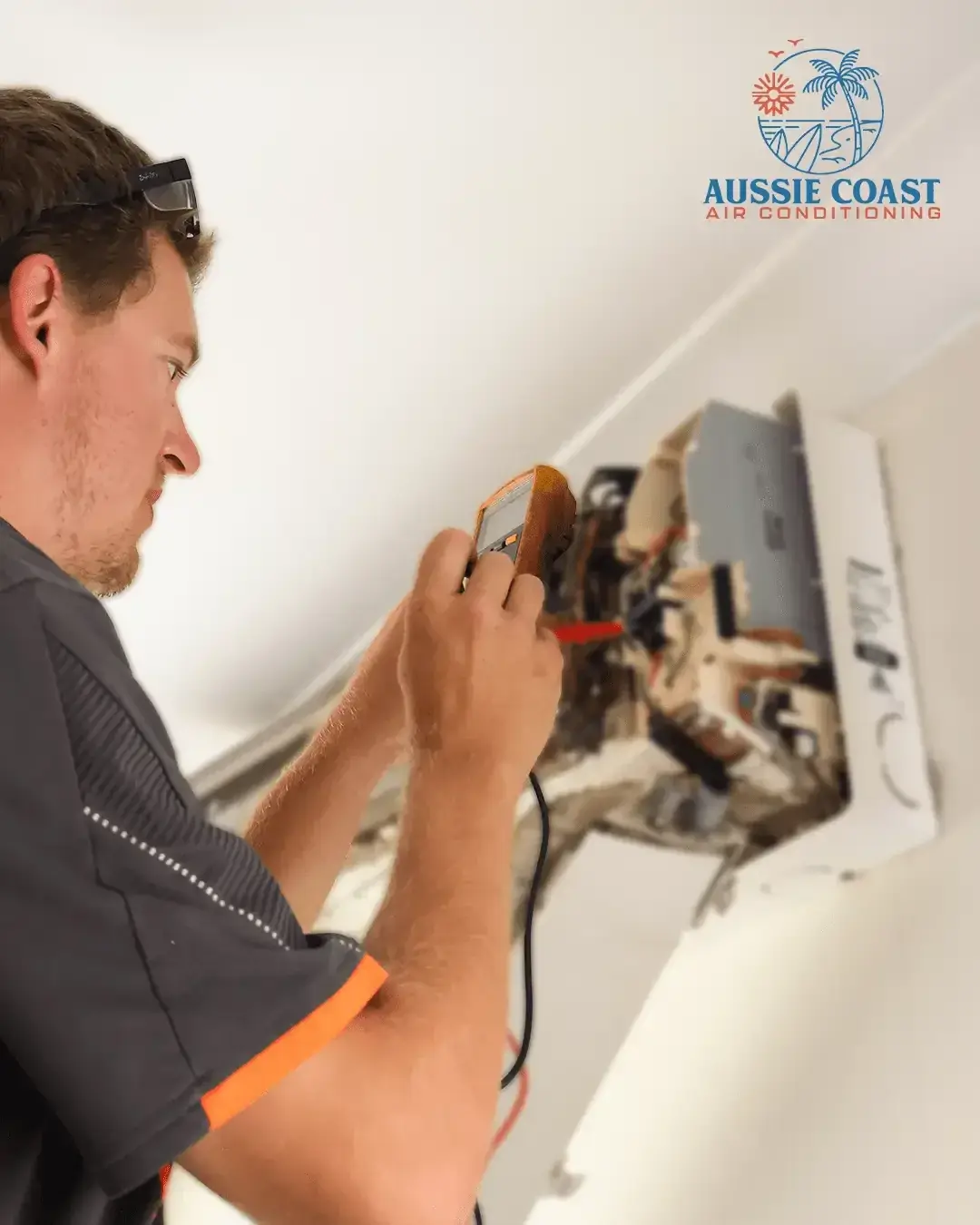 Technician diagnosing an air conditioning fault with a multimeter
