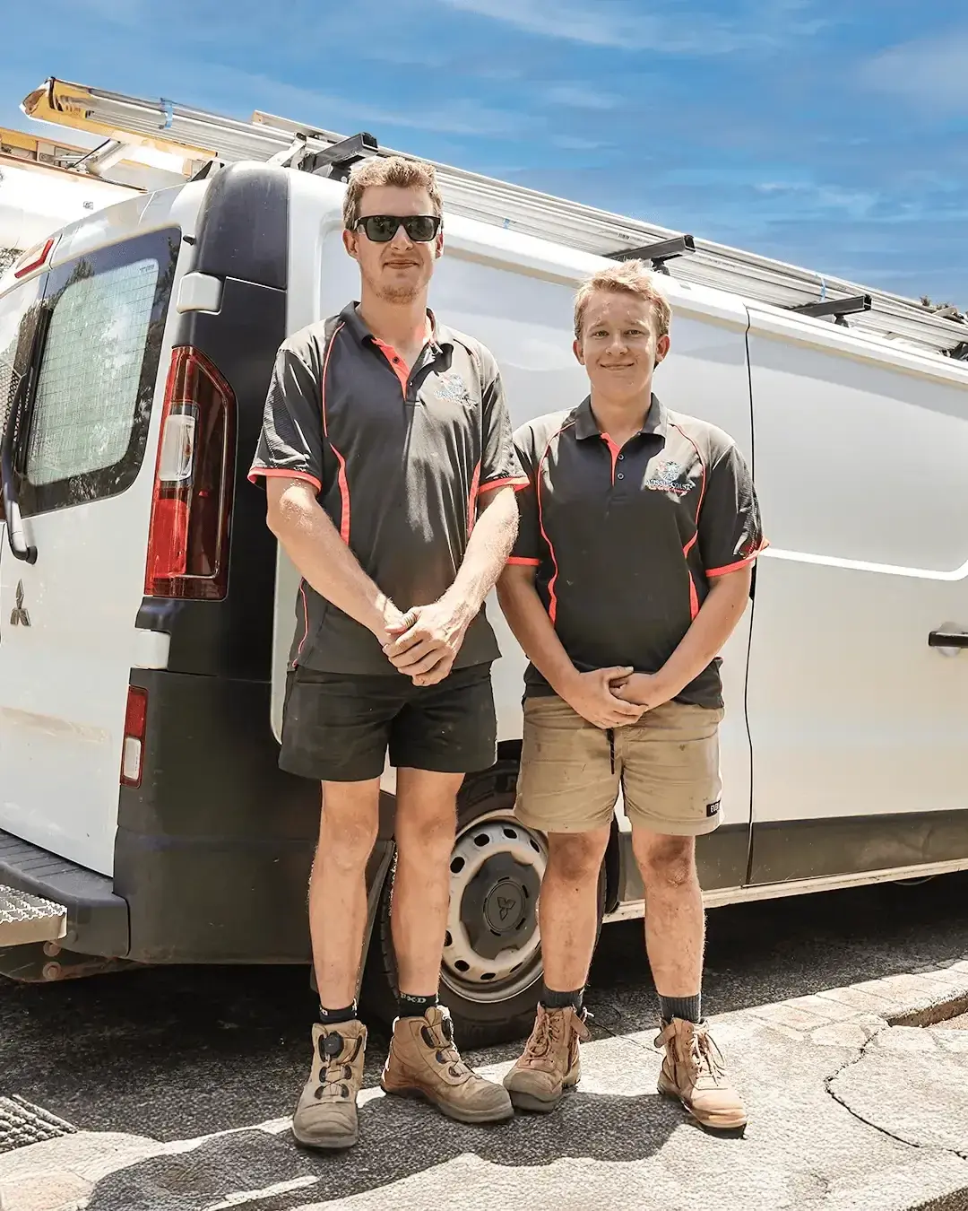 Aussie Coast Air Conditioning technicians standing beside their service van