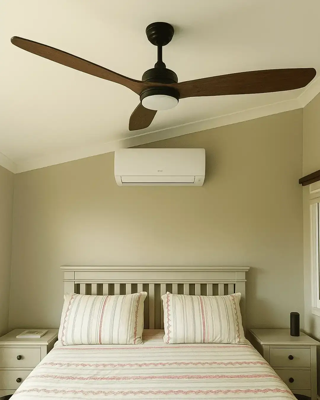 Split system air conditioner above a bed in a comfortable bedroom