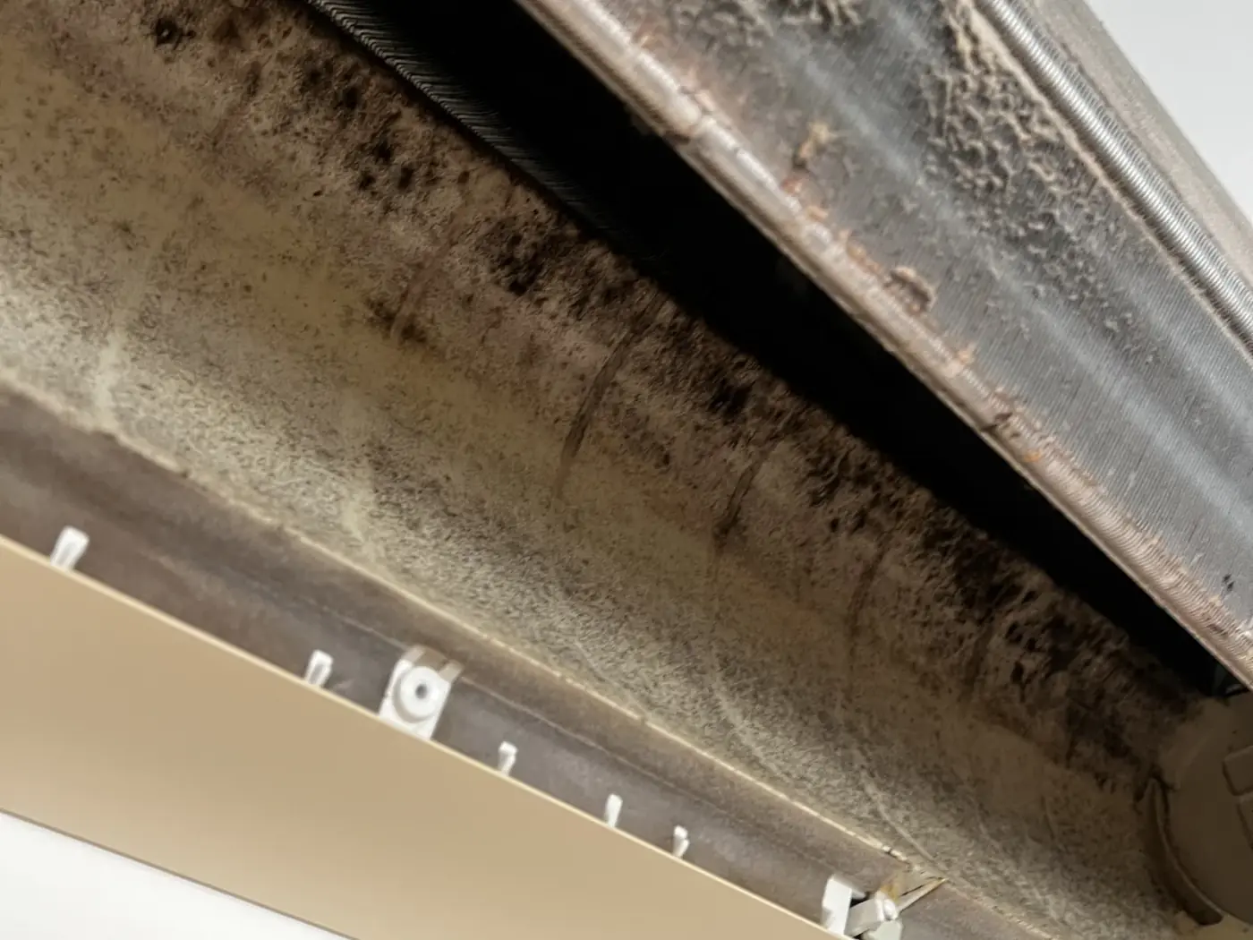 Dust-clogged coil and filter housing inside an unserviced air conditioner in the Shoalhaven