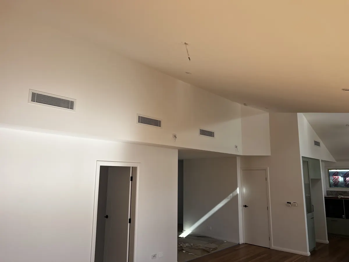 Ducted air conditioning bar grilles along a raked ceiling in a new home, installed by Aussie Coast Air Conditioning