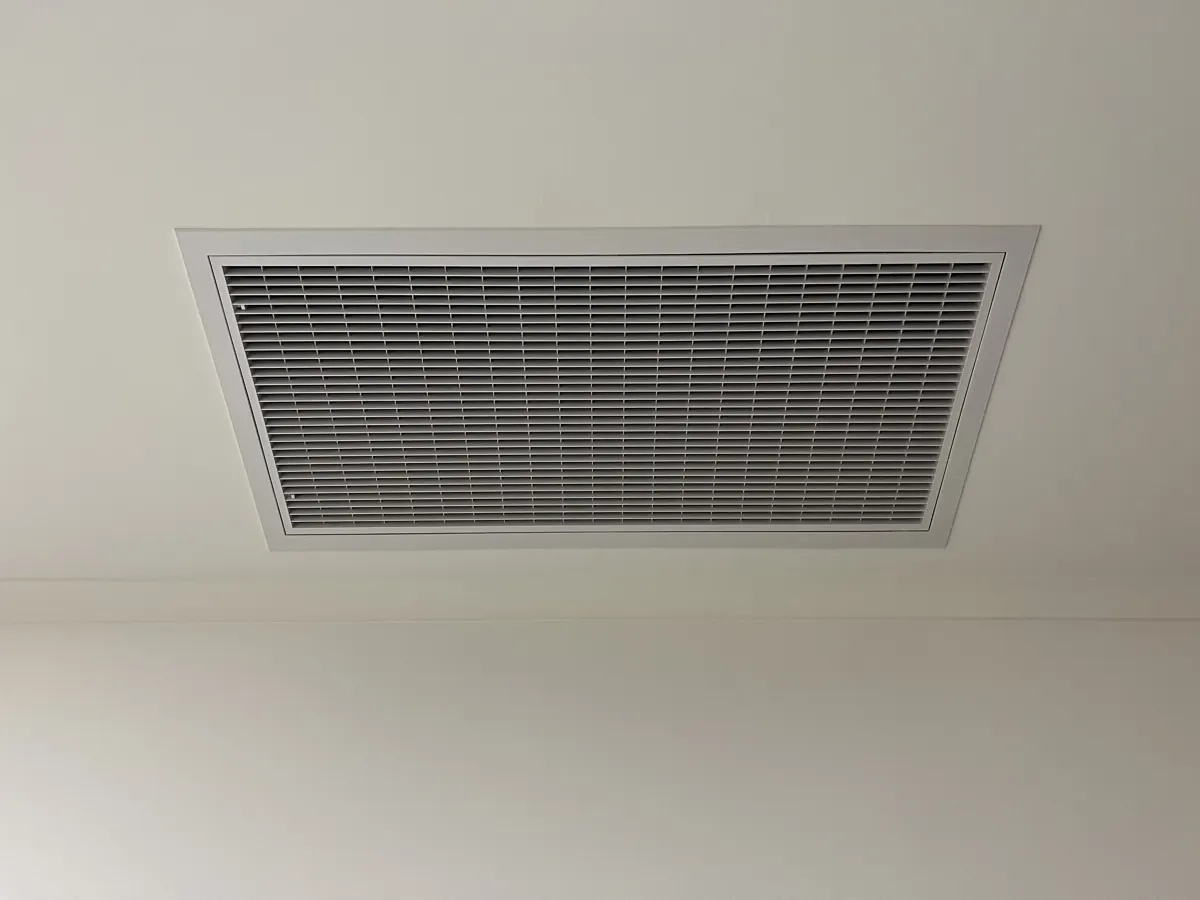 Ducted air conditioning return air grille in a white ceiling