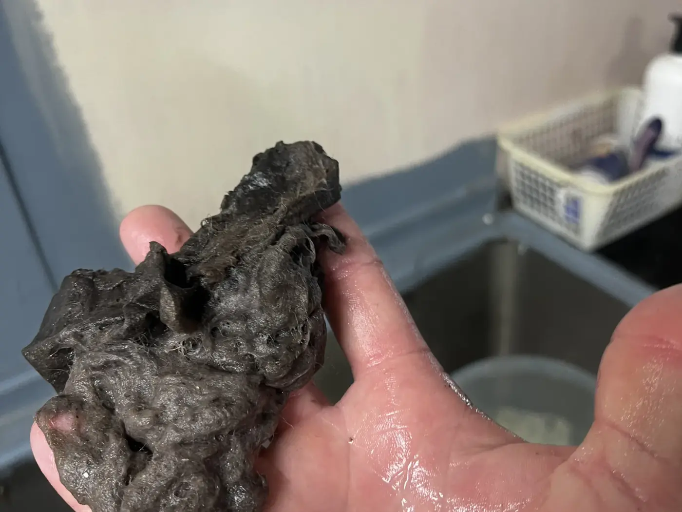 Handful of dust and lint removed from a split system filter during a service