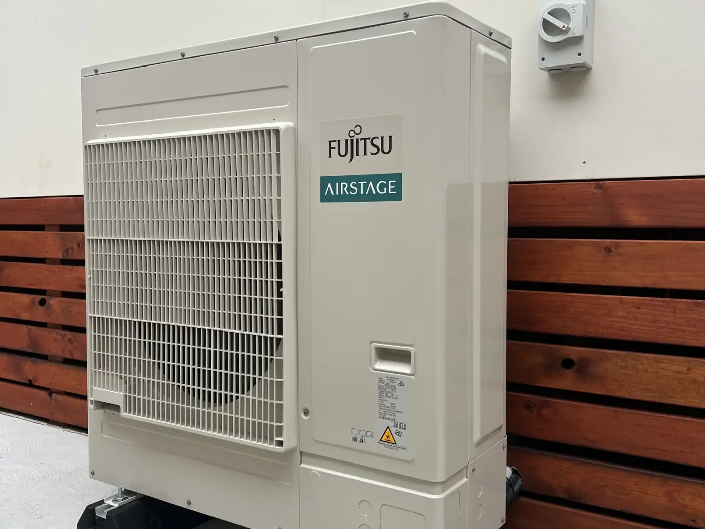 Fujitsu Airstage ducted air conditioning outdoor unit installed on condenser feet in St Georges Basin