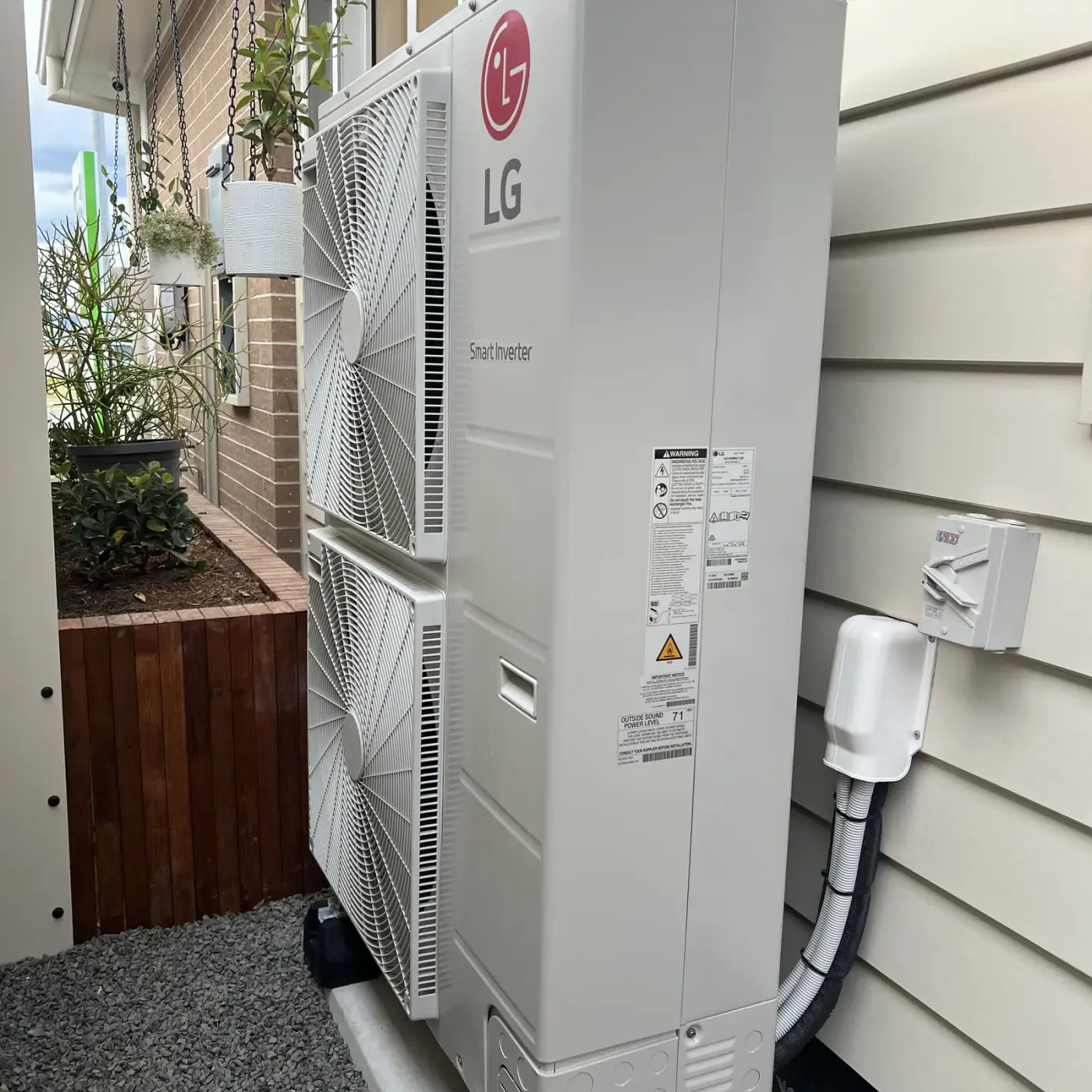 LG air conditioning outdoor unit installed beside a weatherboard home in Berry