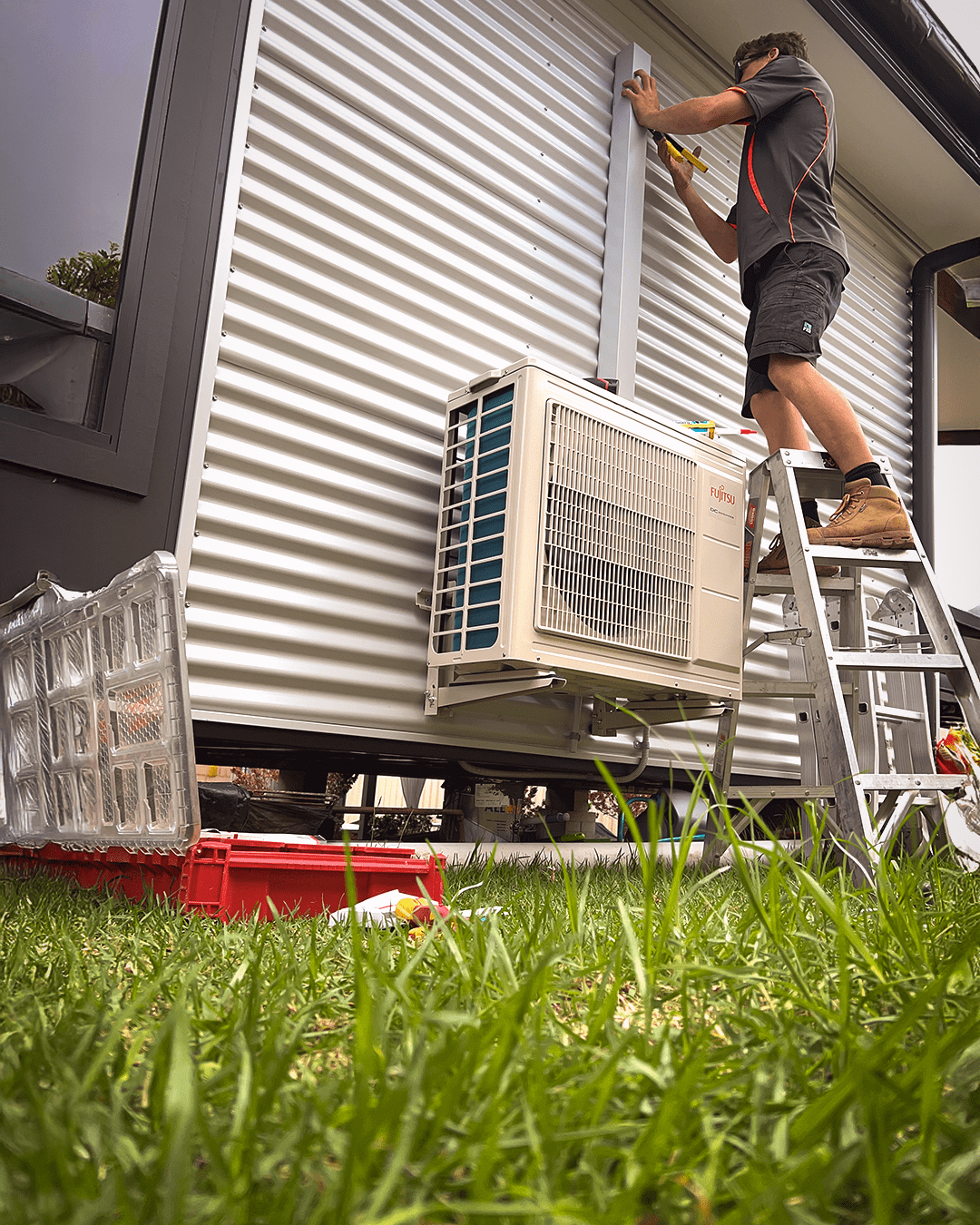 aussie coast man installing air conditioning system